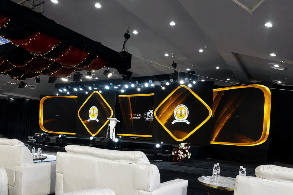 Elegant corporate stage design featuring precise LED pixel mapping and gold geometric shapes by Director Mj.